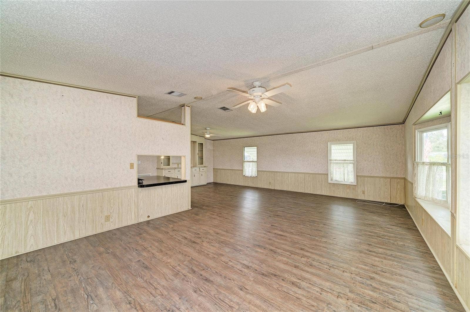 42 MEADOWLARK CIRCLE, Ellenton, FL 34222 Large great room with laminate flooring. Laminate flooring throughout except bedrooms