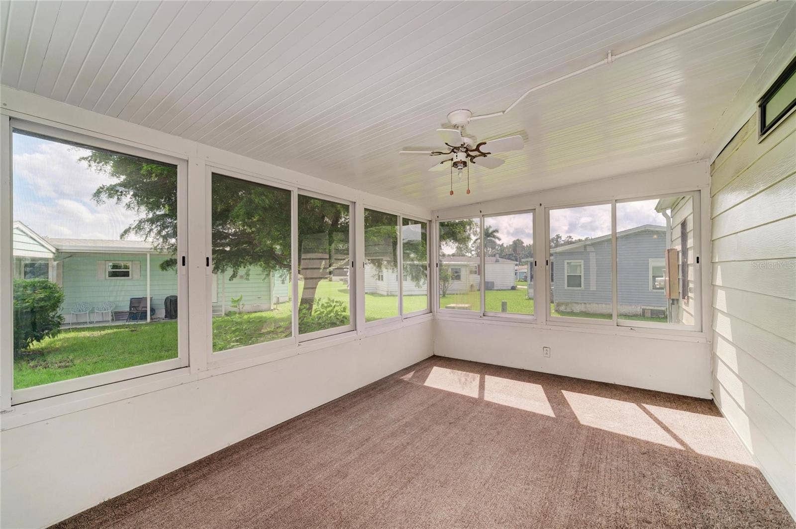 42 MEADOWLARK CIRCLE, Ellenton, FL 34222 Nice and spacious sun room. Just add some pull down shades for added privacy. These are hard plastic windows, Good opportunity to add a mini-split for year round enjoyment. Sunroom accessible from laundry roof with additional door to carport.