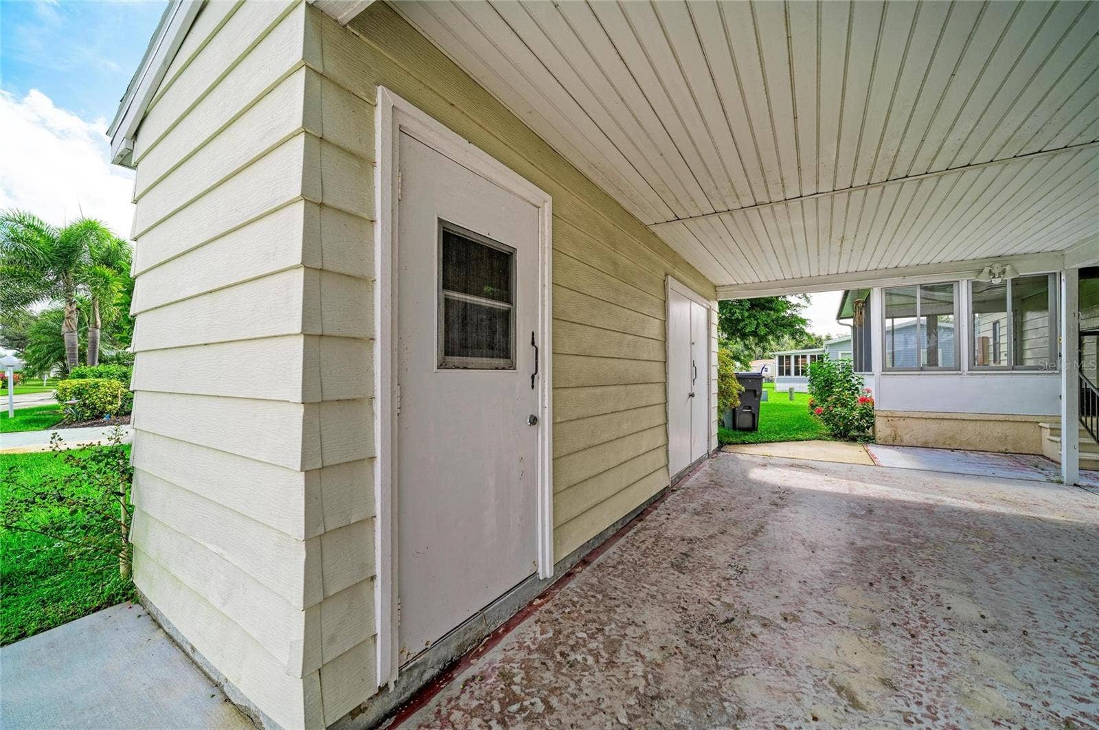 42 MEADOWLARK CIRCLE, Ellenton, FL 34222 Covered carport with additional storage closet with utility sink