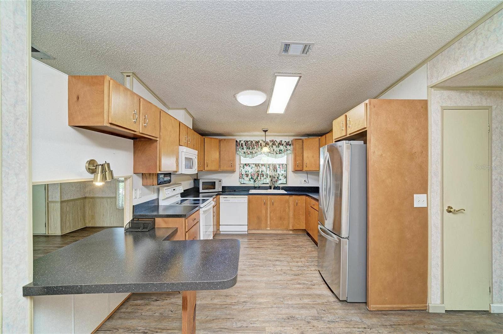 42 MEADOWLARK CIRCLE, Ellenton, FL 34222 Wood cabinet kitchen. Tubular skylight allows for day long lighting. Nice window over sink