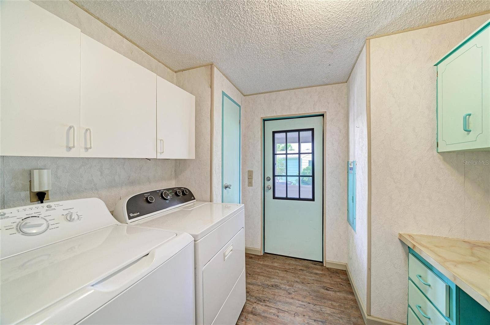42 MEADOWLARK CIRCLE, Ellenton, FL 34222 Inside laundrywith plenty of cabinets for storage and a good size countertop for folding or built in desk