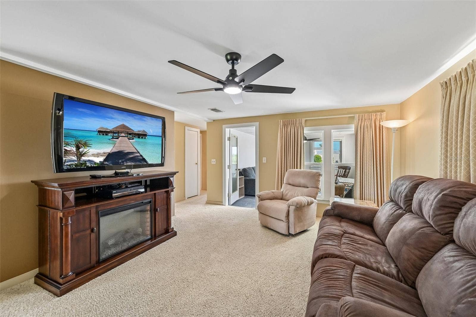 8455 ALBATROSS LANE, Englewood, FL 34224 Living Room with access to Florida Room. Lots of windows!