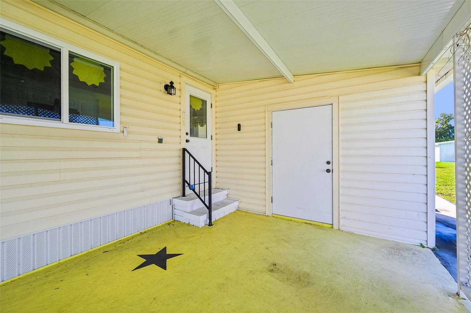 8455 ALBATROSS LANE, Englewood, FL 34224 Covered carport with storage/laundry