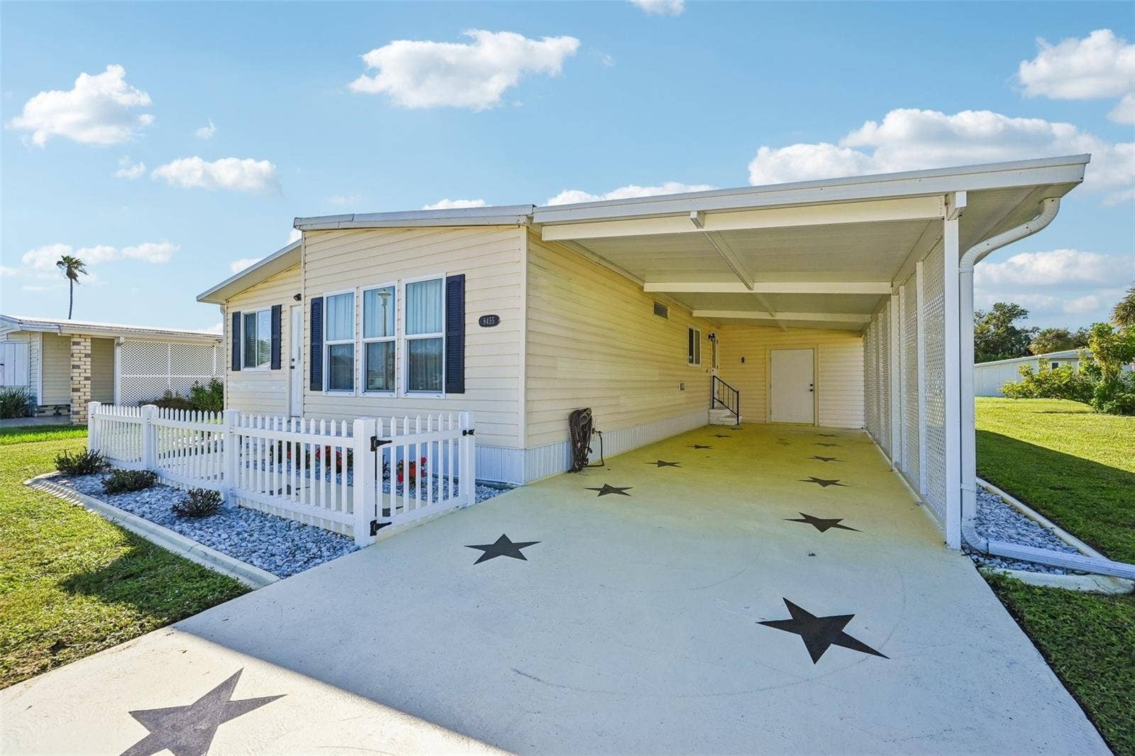 8455 ALBATROSS LANE, Englewood, FL 34224 Long drive-way with covered carport and shed with laundry
