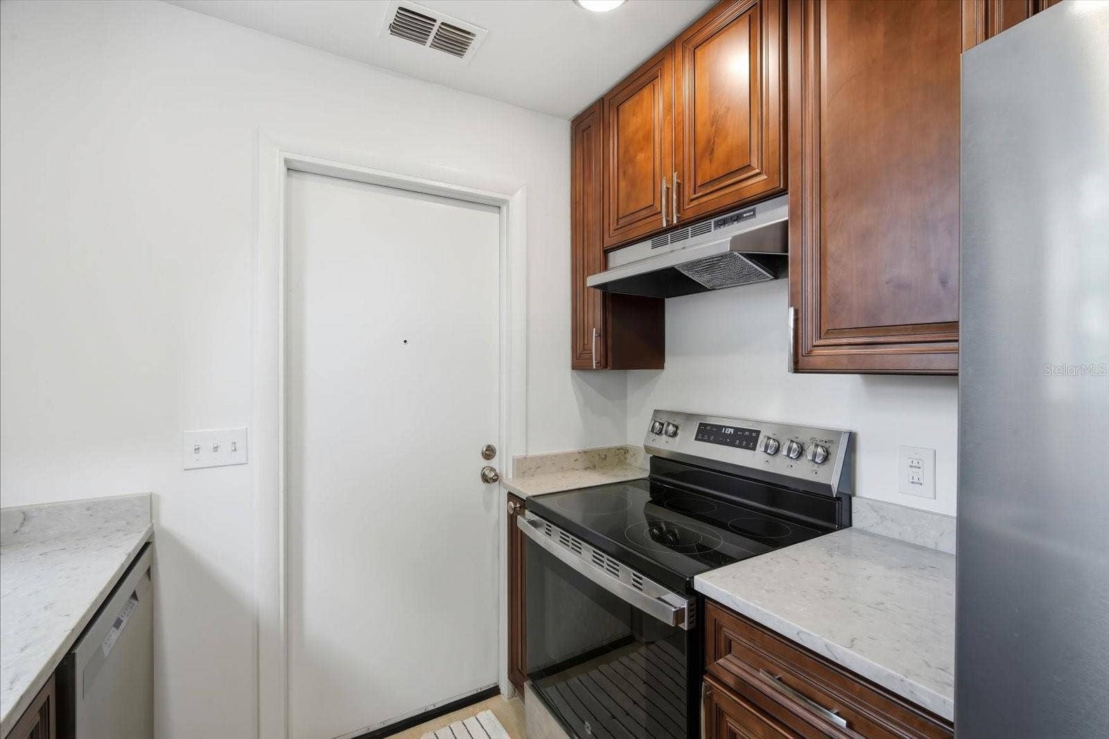 104 CHESAPEAKE AVENUE, #C6, Tampa, FL 33606 kitchen opens to garage with washer & dryer