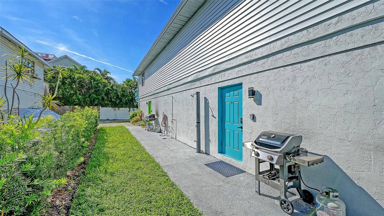 2514 AVENUE B, Bradenton Beach, FL 34217 Both units have left side entrances. Blue door, Unit A. Green door, Unit B. Both units have a propane grill.