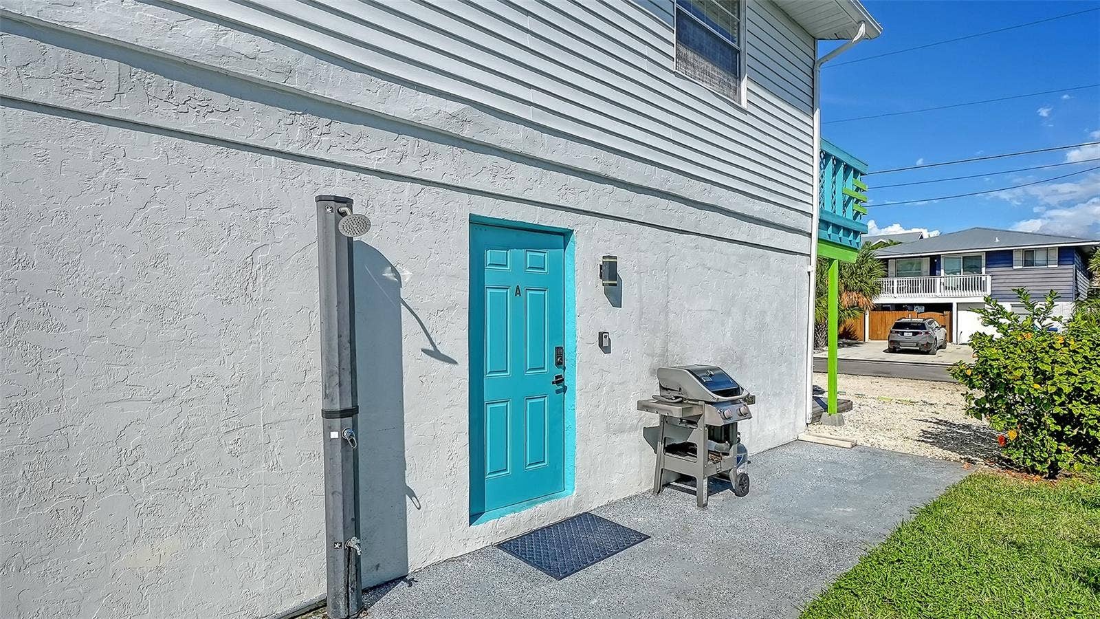 2514 AVENUE B, Bradenton Beach, FL 34217 Both units have left side entrances. Blue door, Unit A. Both units have a propane grill. Common exterior shower that both units share.