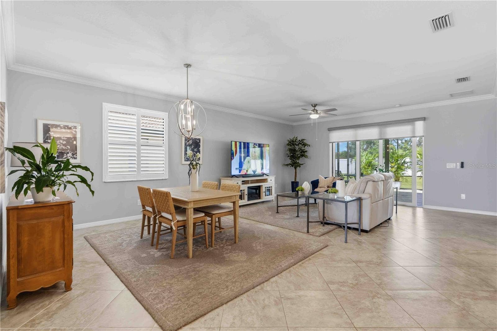 4523 BALTRY COURT, Bradenton, FL 34211 Dining and Living Areas-plantation shutters and motorized shade to the Lanai