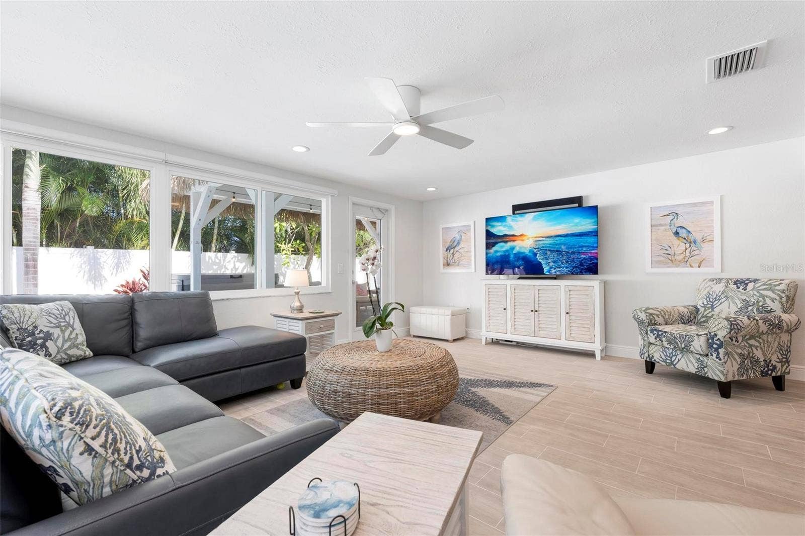 504 69TH STREET, Holmes Beach, FL 34217 Open concept living area with access to the heated pool and tikki covered pergola