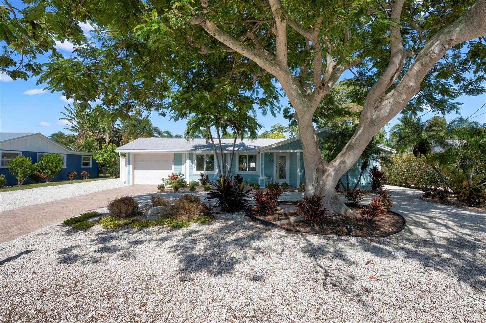 504 69TH STREET, Holmes Beach, FL 34217 Front of home with beautiful poinciana tree