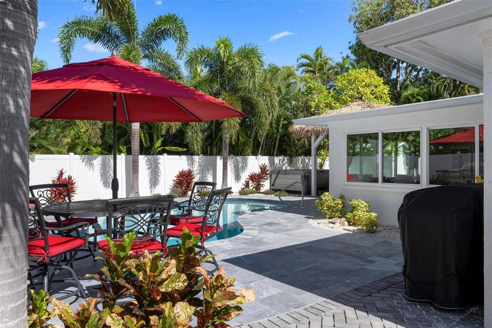504 69TH STREET, Holmes Beach, FL 34217 Pavered outdoor pool patio with heated saltwater pool and hot tub