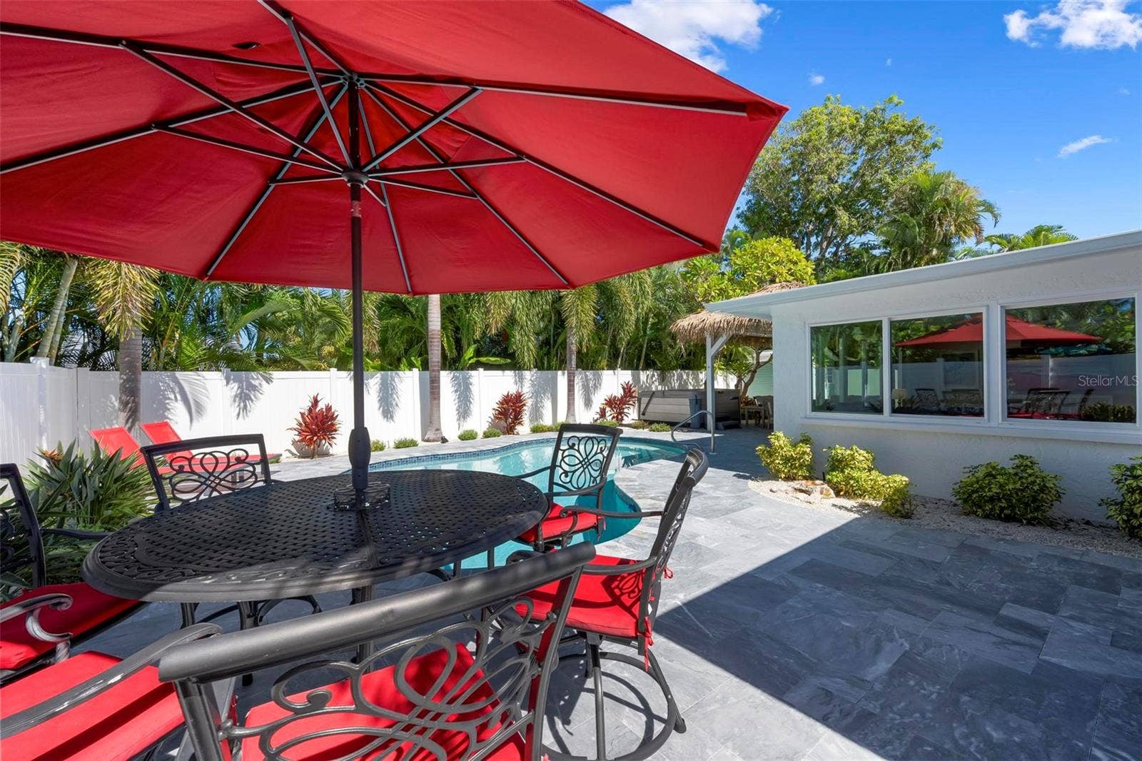 504 69TH STREET, Holmes Beach, FL 34217 Pavered outdoor pool patio with heated saltwater pool and hot tub