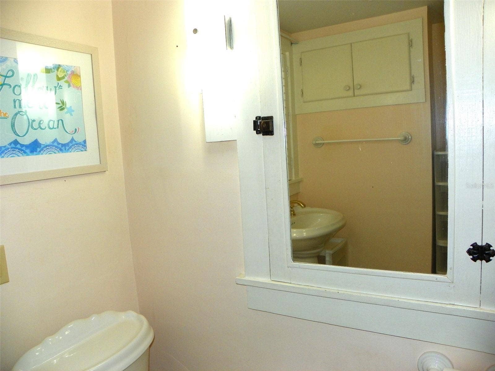 8 PLAZA STREET E, Bradenton, FL 34208 Bathroom w/built-in medicine chest.