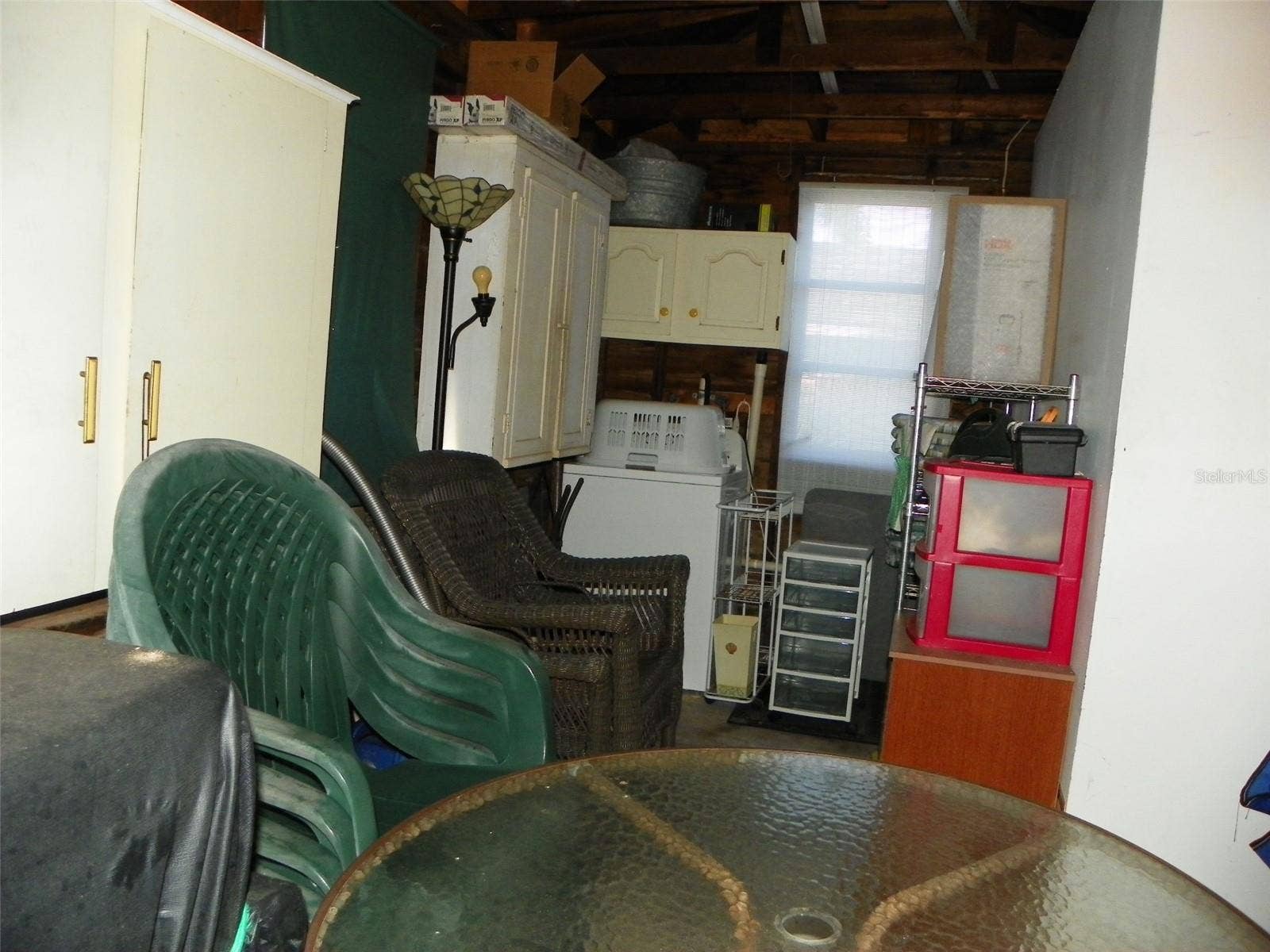 8 PLAZA STREET E, Bradenton, FL 34208 Storage area with washer.