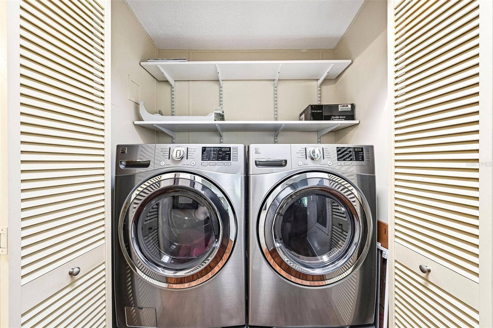 8510 COUNTESS AVENUE CIRCLE, Palmetto, FL 34221 Front Loading Washer & Dryer in Closet in Hallway