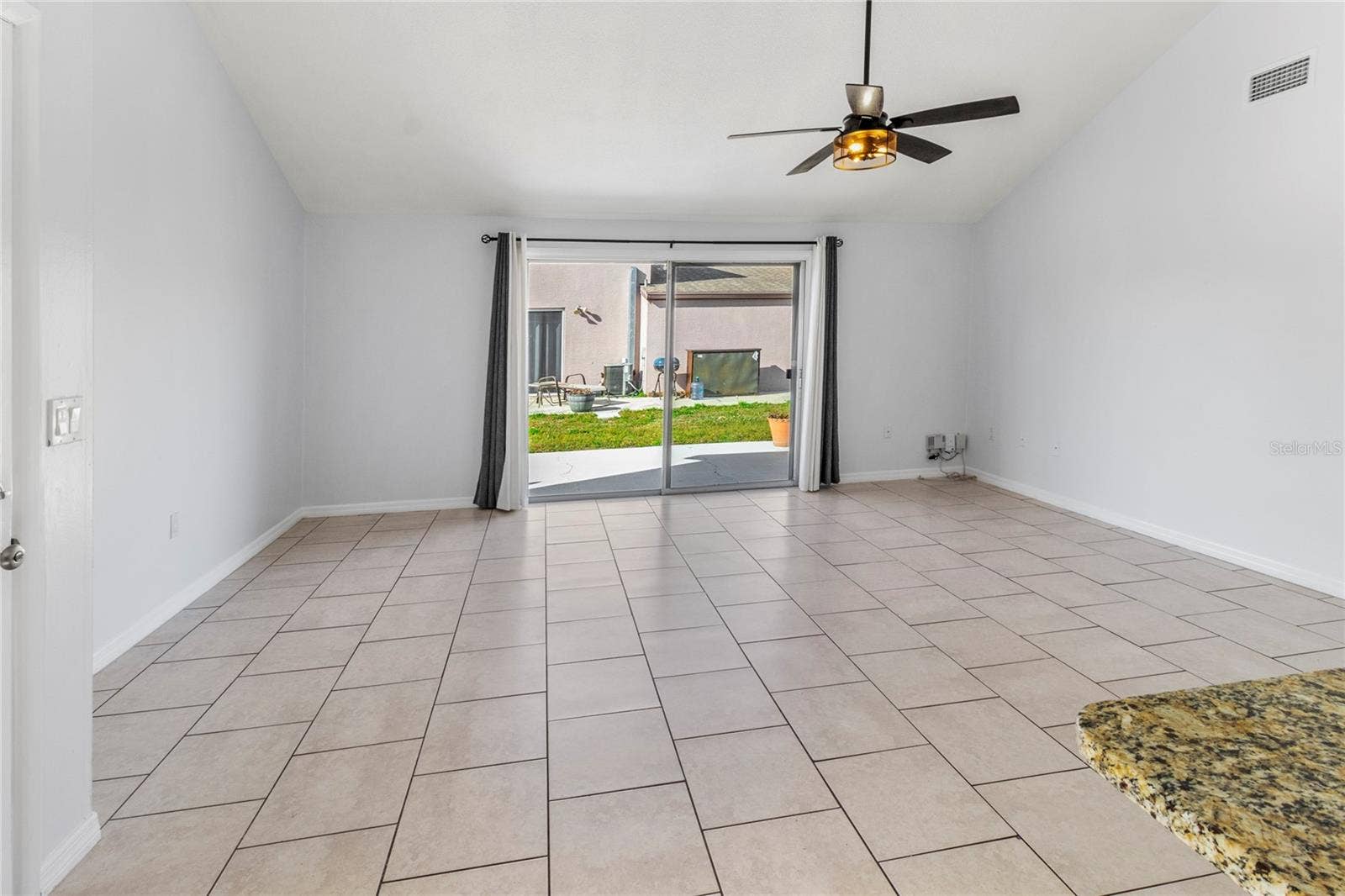 7013 BRENTFORD ROAD, Sarasota, FL 34241 Living Room | There is now a white vinyl fence separating these two homes - so very private now and no more view of the neighbors!