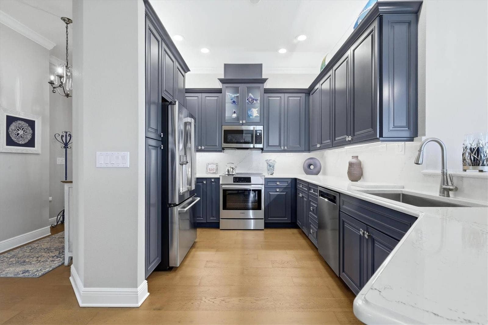 7920 34TH AVENUE W, #303, Bradenton, FL 34209 Kitchen has custom cabinetry, quartz countertops.