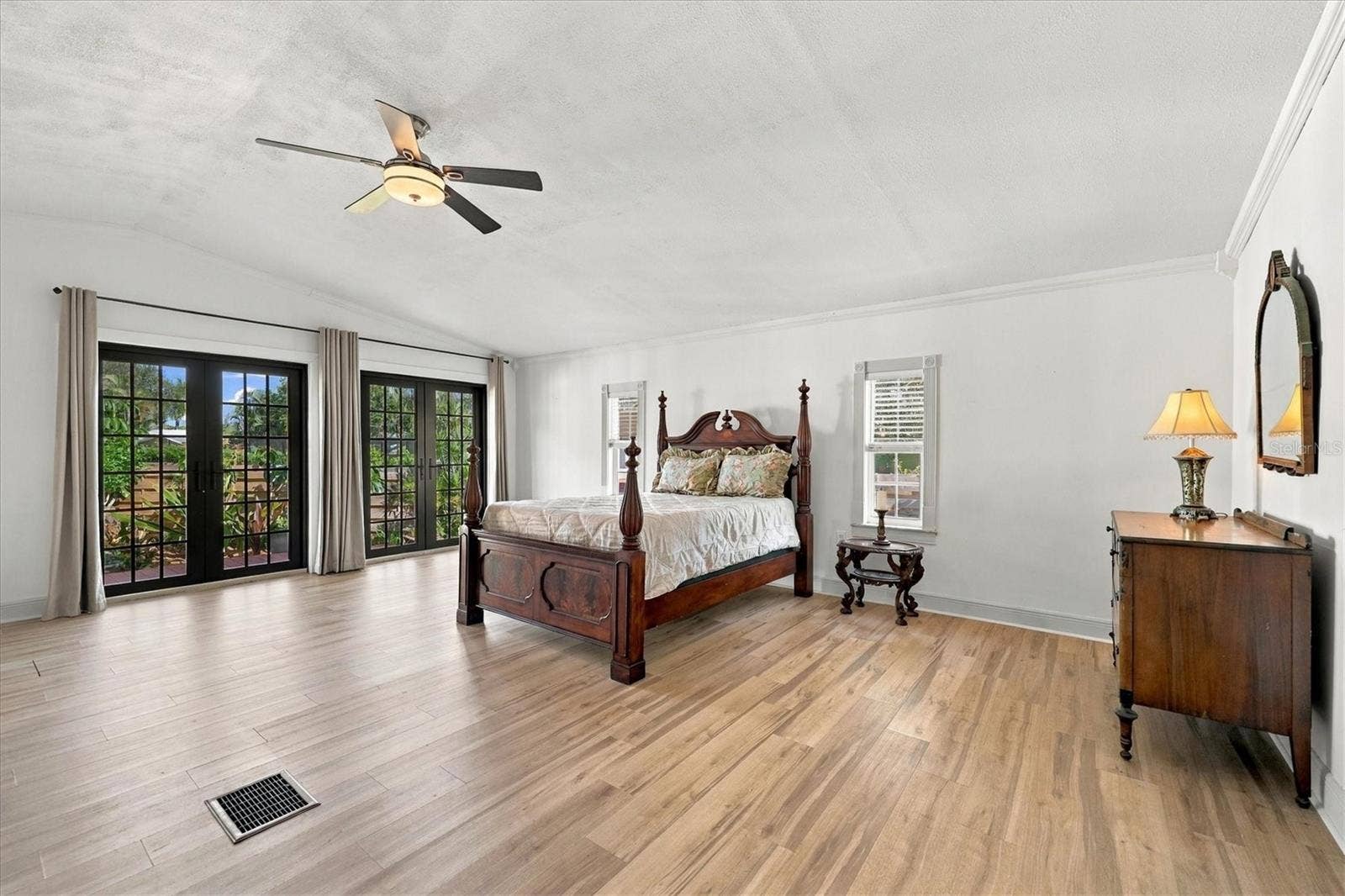 5208 HARBOR ROAD, Bradenton, FL 34209 Primary Bedroom with french doors to the outdoor patio