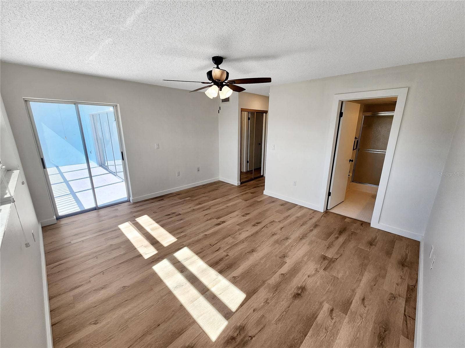Primary bedroom with door to balcony