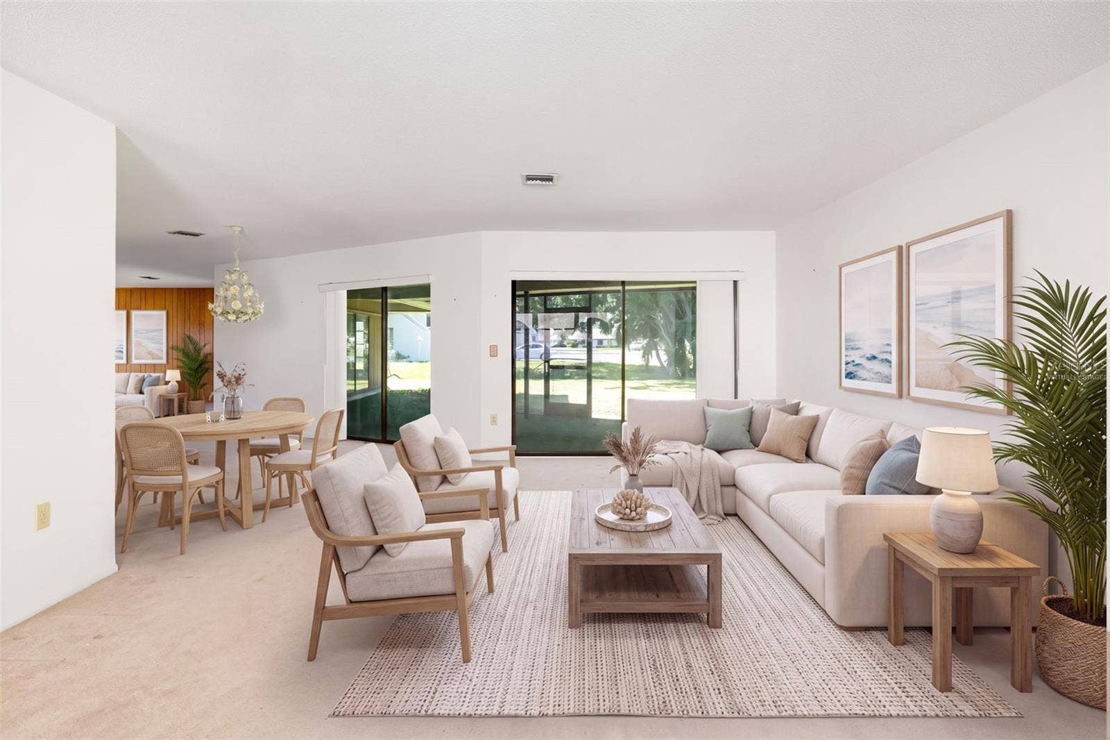 Virtually Staged. Spacious living and dining area with sliders to the screened lanai.