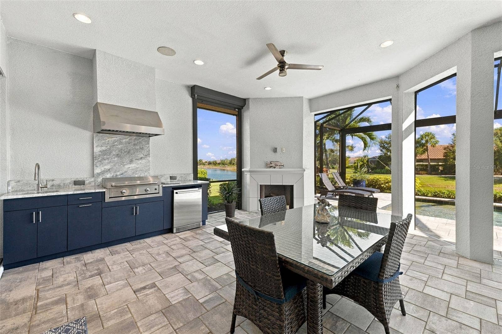 4723 BENITO COURT, Bradenton, FL 34211 Outdoor Kitchen and Dining with a Fireplace
