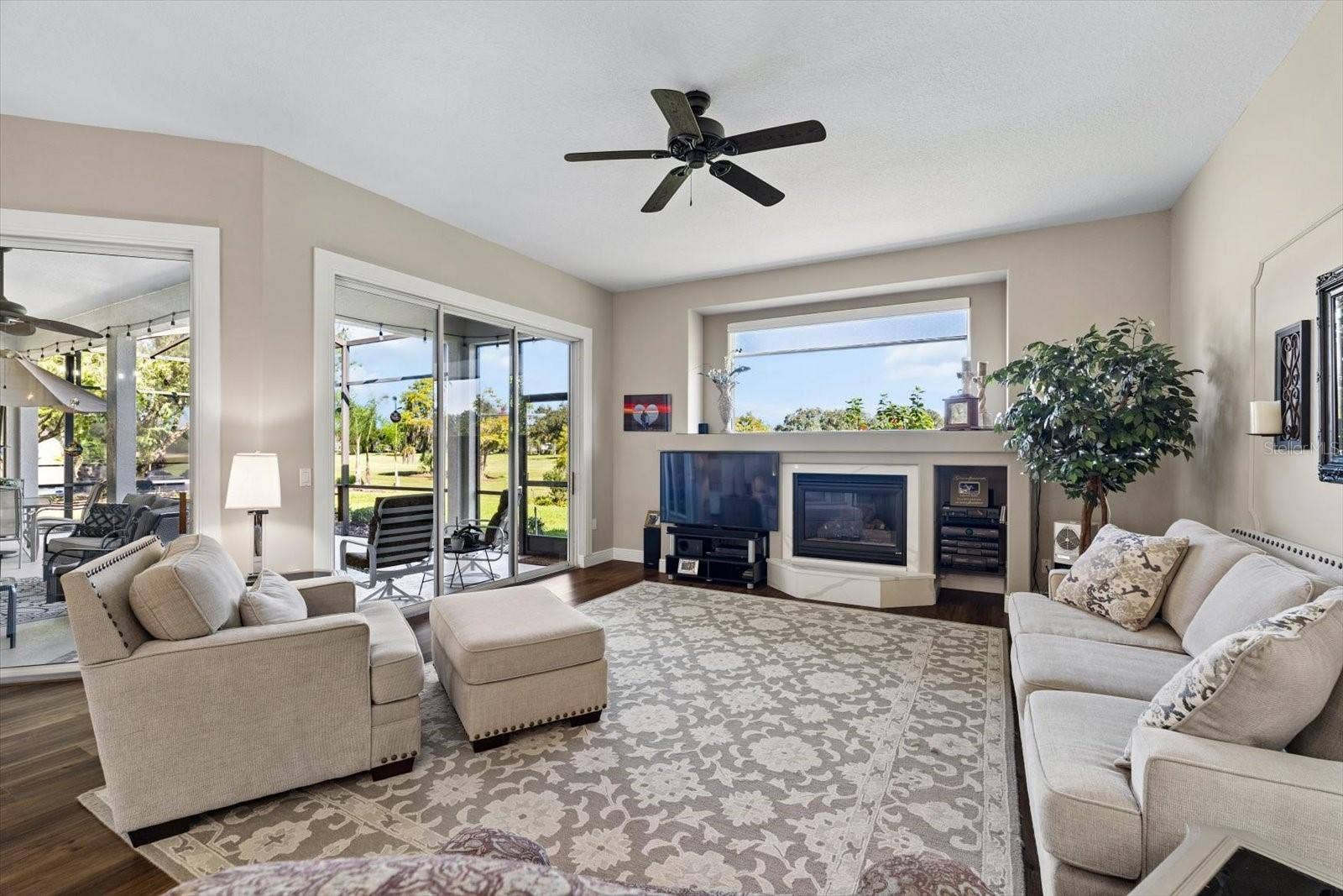 9921 LAUREL VALLEY AVENUE CIRCLE, Bradenton, FL 34202 Family room with 2 sets of sliders providing that indoor outdoor Florida lifestyle