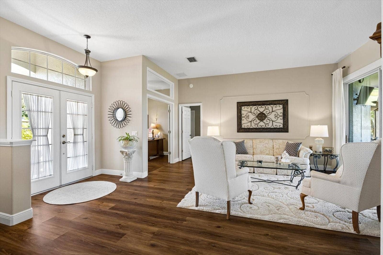9921 LAUREL VALLEY AVENUE CIRCLE, Bradenton, FL 34202 Formal living room overlooking the patio and golf course