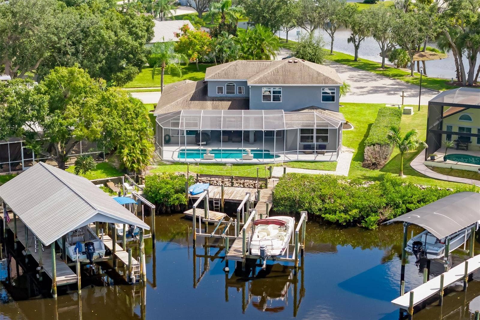 124 41ST CIRCLE E, Bradenton, FL 34208 Back Elevation - Culdesac on Canal - Two Boat lifts and a floating dock for accessing Kayaks