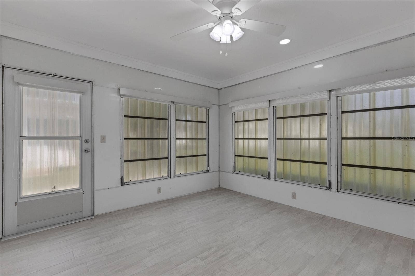 1311 BOTTLEBRUSH DRIVE, Bradenton, FL 34208 Lanai with storm shutters installed.