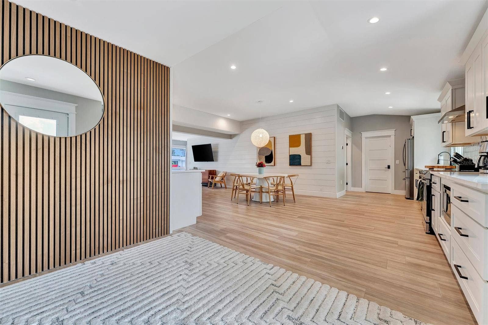 10115 KINGFISHER ROAD E, Bradenton, FL 34209 Extensively updated with 2023 roof, 2022 AC, newer rear windows, flood barriers, wood-look tile, neutral finishes, and open living/dining area.