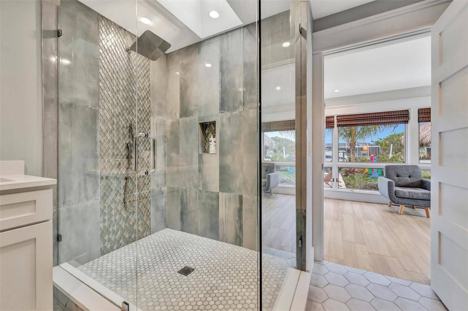 10115 KINGFISHER ROAD E, Bradenton, FL 34209 Spacious primary ensuite with double vanity and walk-in rain shower.