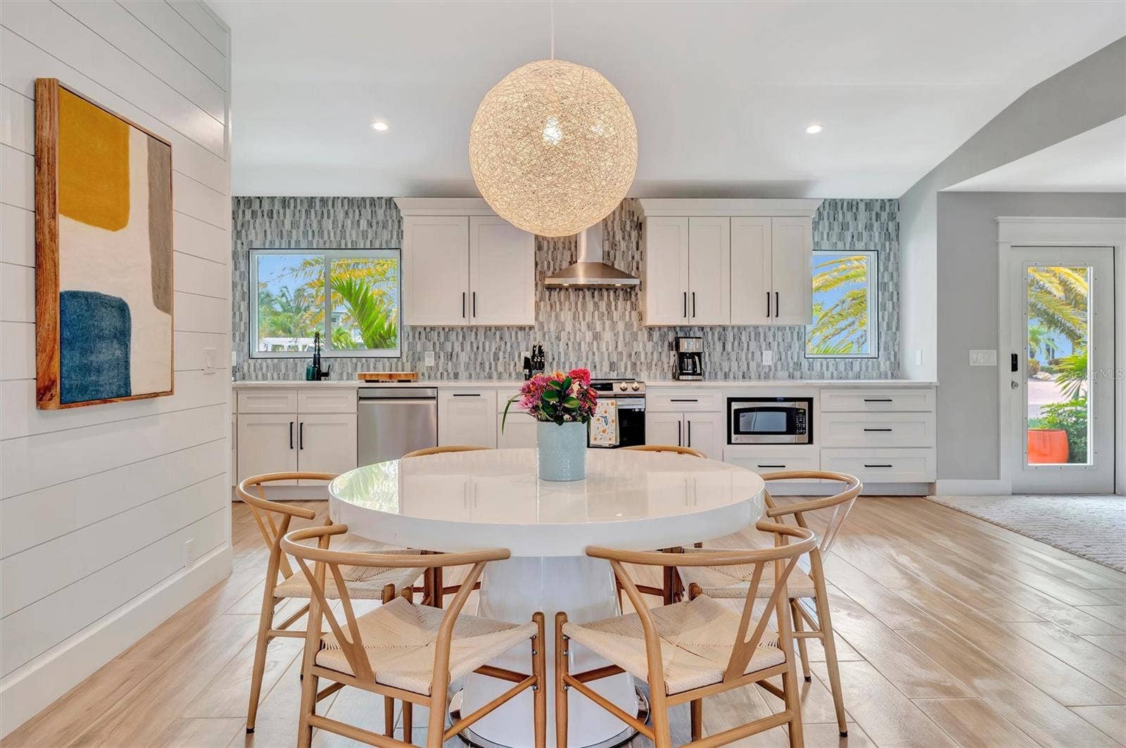 10115 KINGFISHER ROAD E, Bradenton, FL 34209 Extensively updated with 2023 roof, 2022 AC, newer rear windows, flood barriers, wood-look tile, neutral finishes, and open living/dining area.