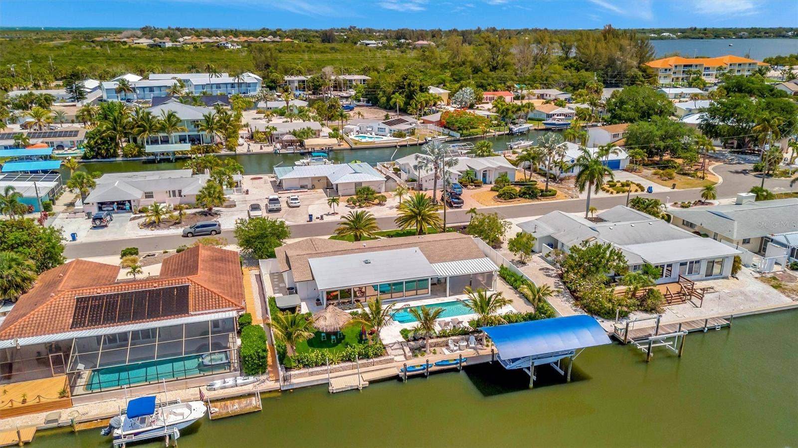 10115 KINGFISHER ROAD E, Bradenton, FL 34209 Approximately 90 feet of waterfront, updated seawall, composite dock, floating kayak/paddleboard dock, and covered 10,000-lb remote boat lift.