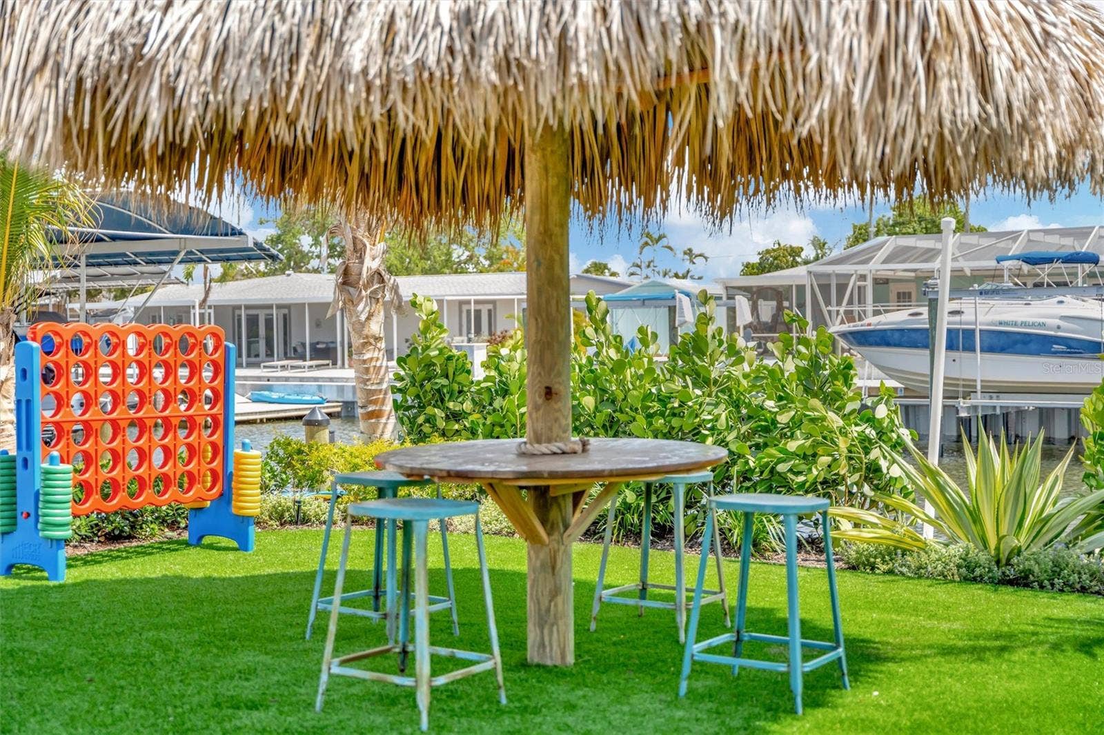 10115 KINGFISHER ROAD E, Bradenton, FL 34209 Covered lanai, multiple terraces, built-in propane grill, and tiki hut with turf games area.