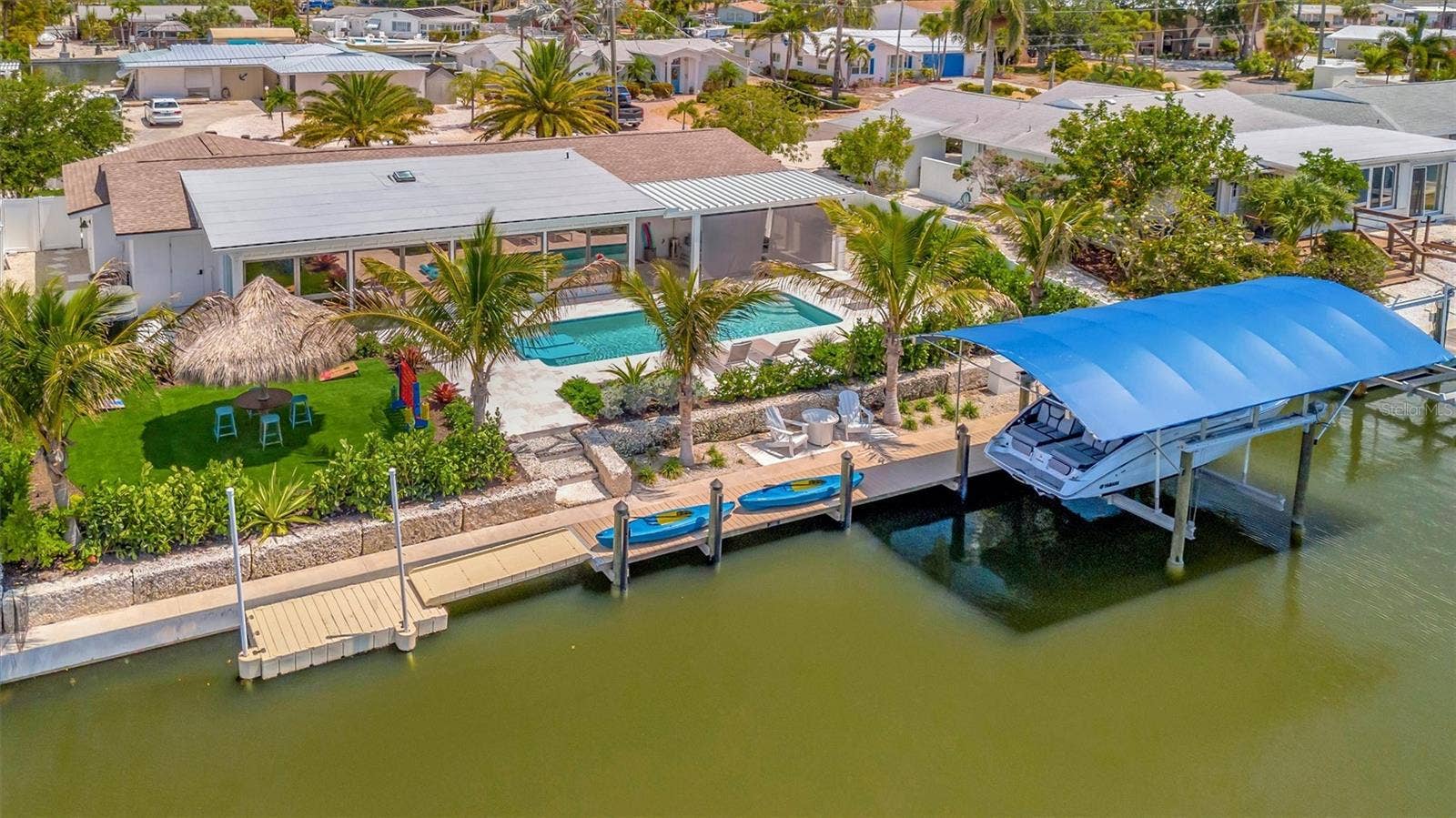 10115 KINGFISHER ROAD E, Bradenton, FL 34209 Approximately 90 feet of waterfront, updated seawall, composite dock, floating kayak/paddleboard dock, and covered 10,000-lb remote boat lift.