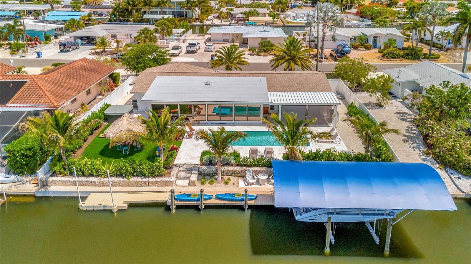 10115 KINGFISHER ROAD E, Bradenton, FL 34209 Extensively updated with 2023 roof, 2022 AC, newer rear windows, flood barriers, wood-look tile, neutral finishes, and open living/dining area.
