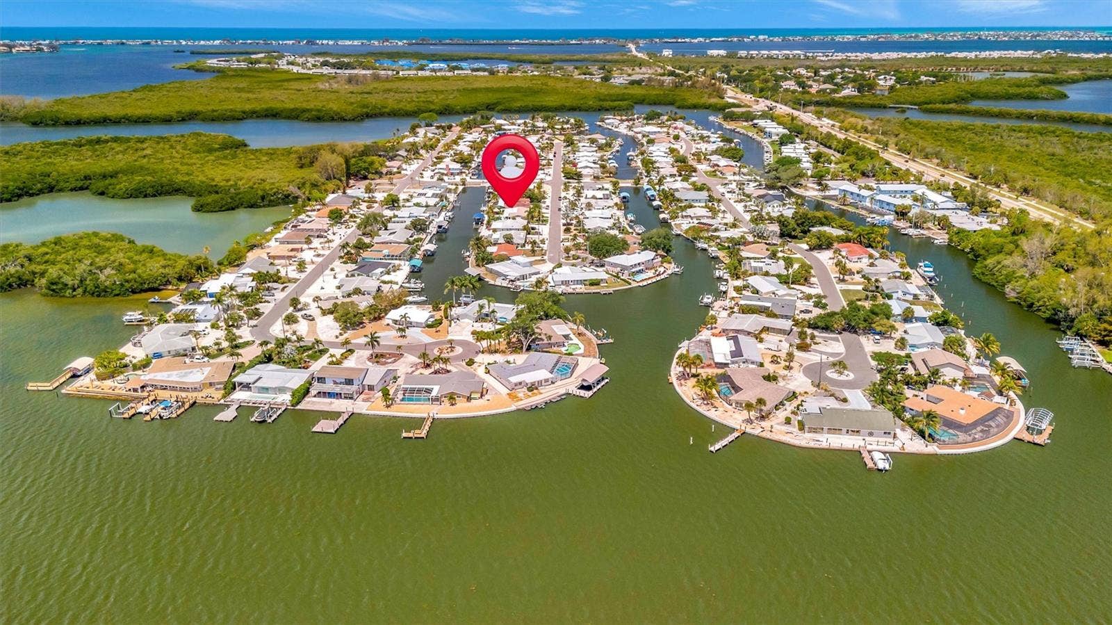 10115 KINGFISHER ROAD E, Bradenton, FL 34209 Approximately 90 feet of waterfront, updated seawall, composite dock, floating kayak/paddleboard dock, and covered 10,000-lb remote boat lift.