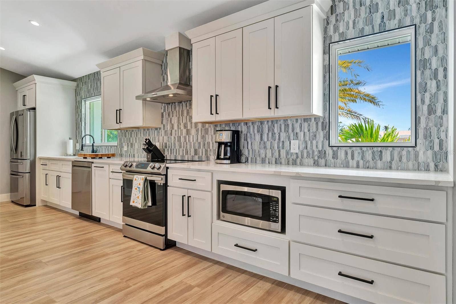 10115 KINGFISHER ROAD E, Bradenton, FL 34209 Chef-inspired kitchen with quality appliances, wine and beverage refrigerators, and wet bar.