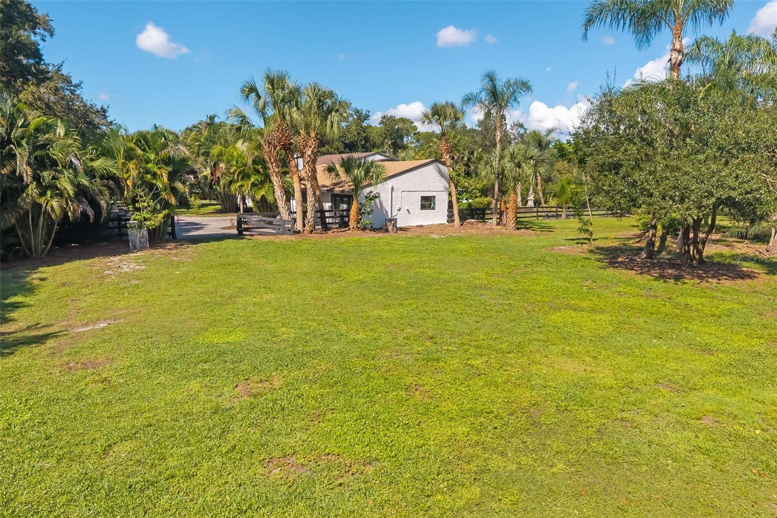 403 LONGBOW TRAIL, Osprey, FL 34229 Imagine the possibilities: ample open space for a future RV, boat or collector-car garage, workshop, barn or other accessory structure, subject to Pine Ranch and Sarasota County requirements.