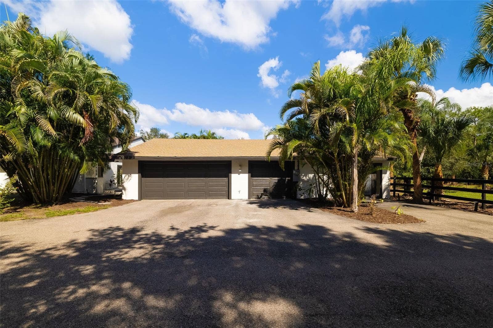 403 LONGBOW TRAIL, Osprey, FL 34229 CAR ENTHUSIASTS TAKE NOTEthis substantial extended three-car garage provides exceptional space for vehicles, storage, tools, hobbies and more.
