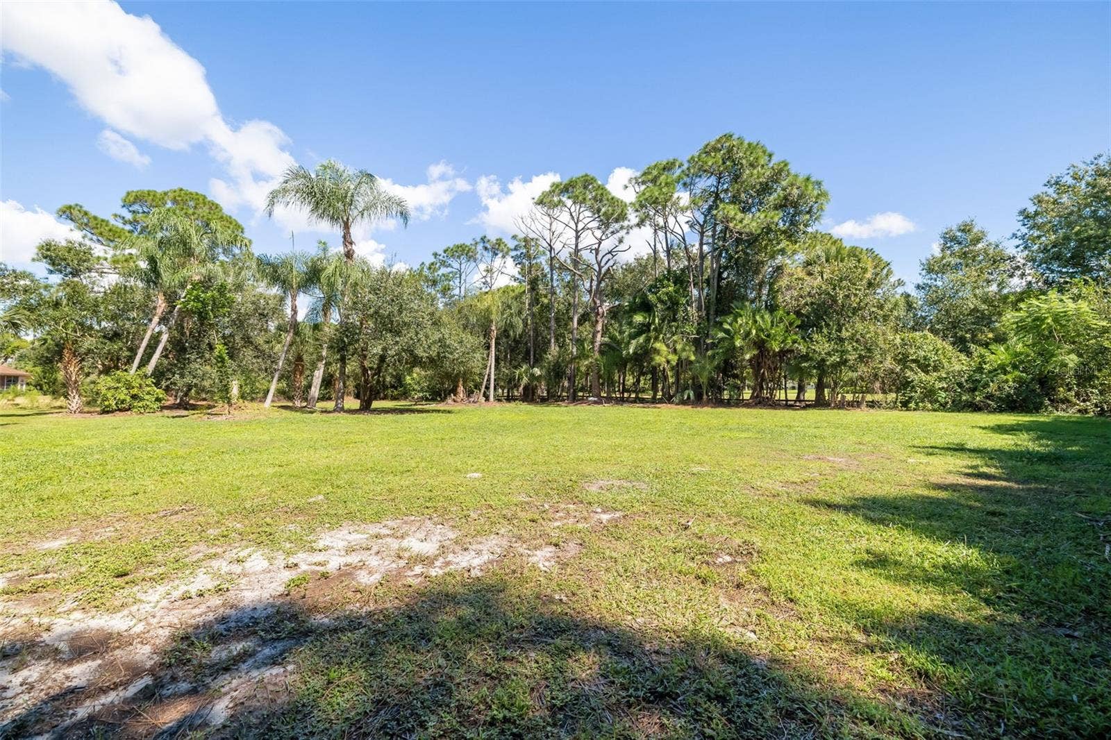 403 LONGBOW TRAIL, Osprey, FL 34229 Expansive open acreage offering potential for a future RV/boat garage, collector-car garage, workshop, barn or other accessory structure, subject to applicable approvals.