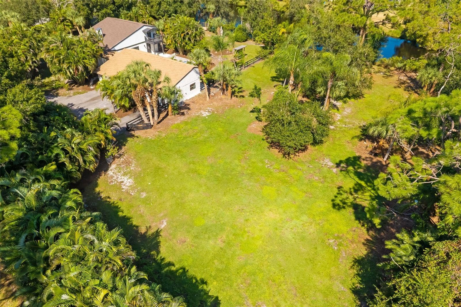 403 LONGBOW TRAIL, Osprey, FL 34229 Aerial view highlighting the generous open area of this two-acre propertyan exceptional opportunity to explore additional garage, workshop, recreational or equestrian uses, subject to applicable approvals.