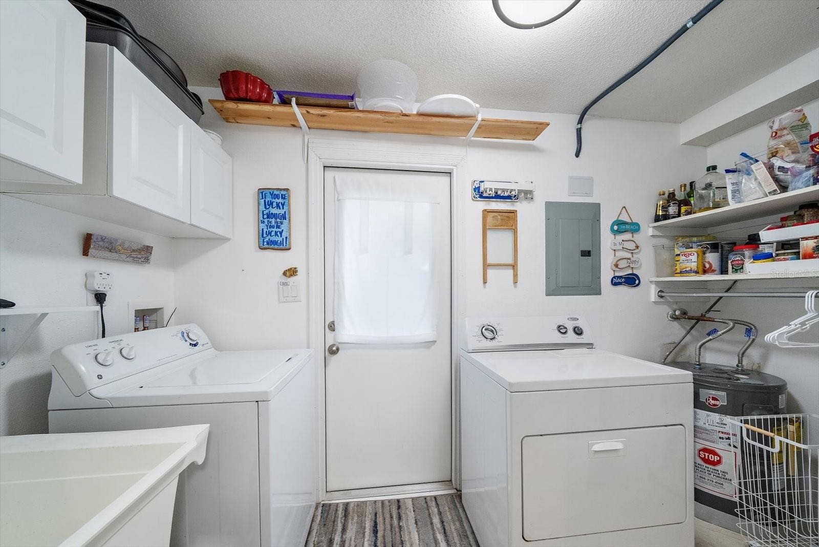 full laundry room off of the kitchen, with exit door