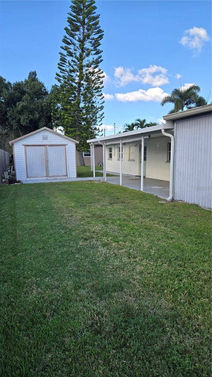Back yard with storage shed and rear patio