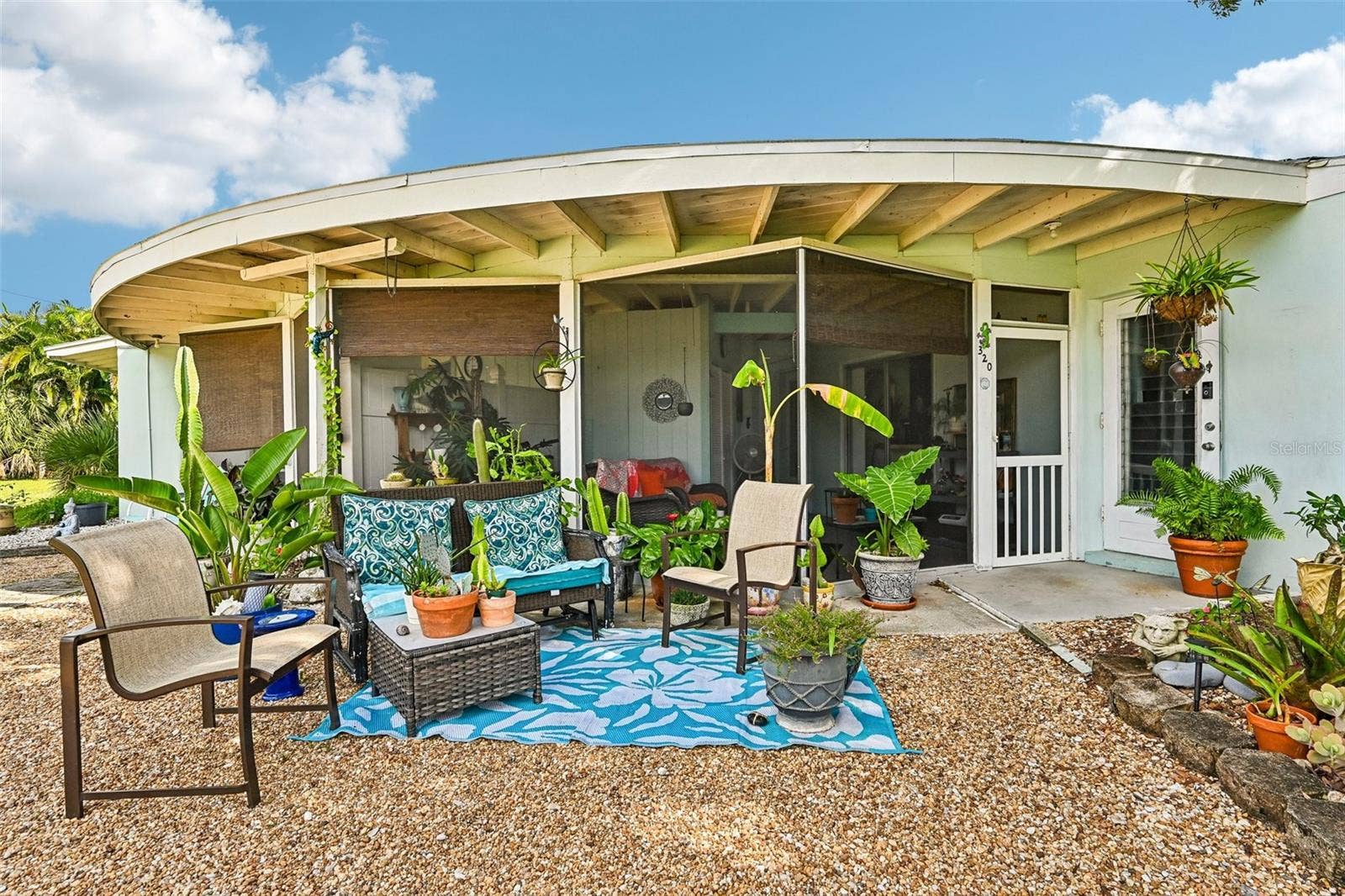 320 - front door, screened lanai and outdoor seating / garden area