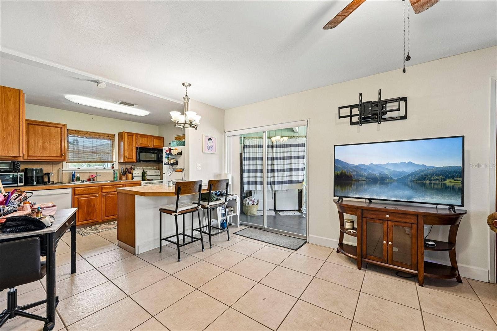 322 - glass sliders to lanai and laundry; open plan living room / kitchen / casual dining
