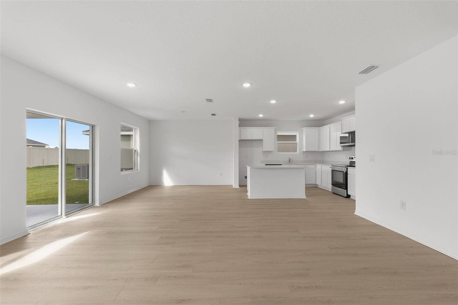13009 RED DEER PL, Parrish, FL 34219 Open concept living, dining, and kitchen