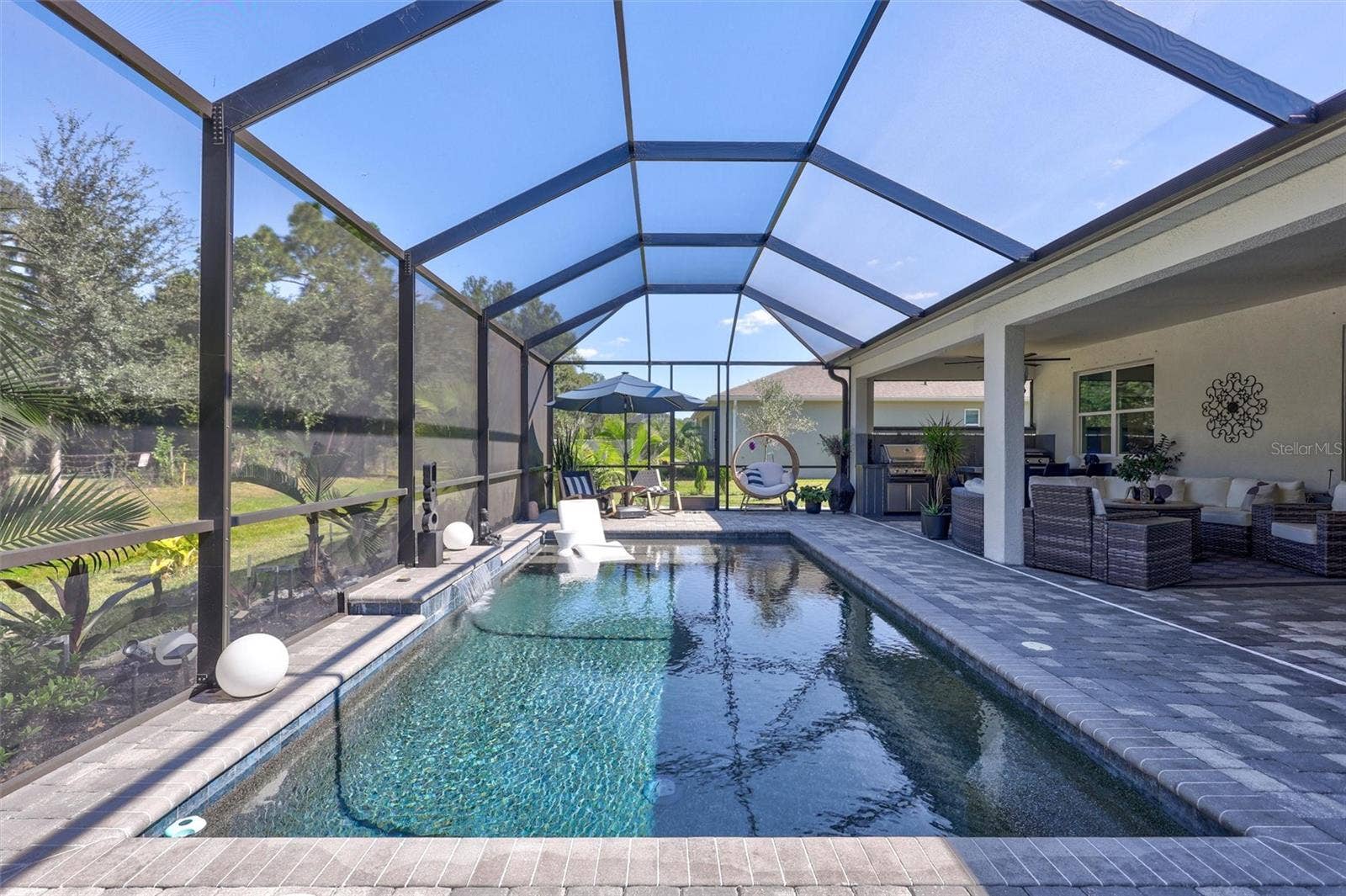 Premium PebbleTec Finish with Sunshelf, private screened room surround by beautiful pavers and peaceful wooded views