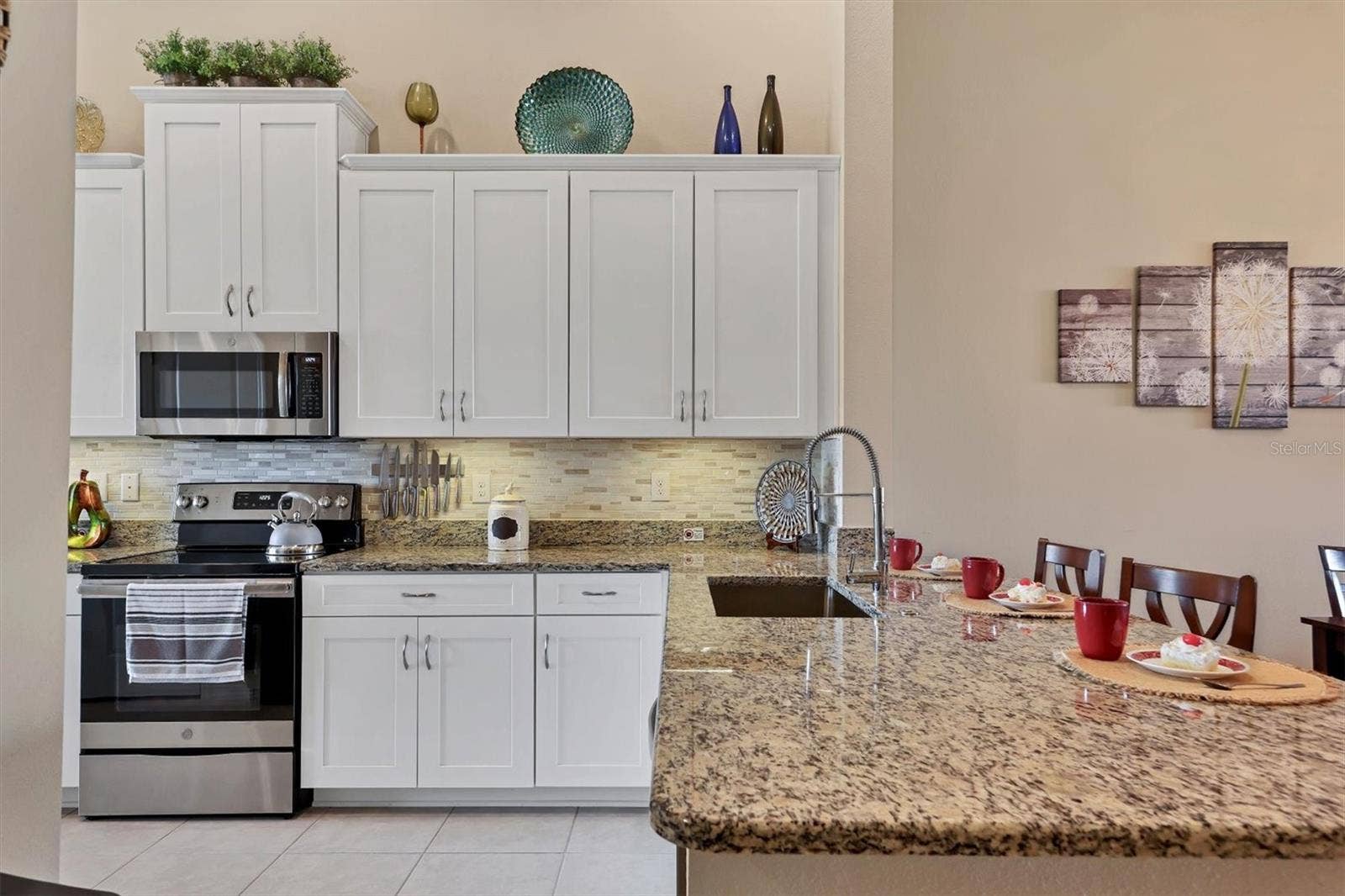 13719 MESSINA LOOP, #202, Lakewood Ranch, FL 34211 Granite Counters, stainless applicances and tall wooden cabinetry