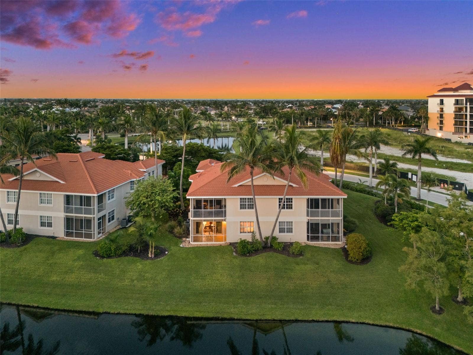 5626 CAPE HARBOUR DRIVE, #102, Cape Coral, FL 33914 Evening View of the Back